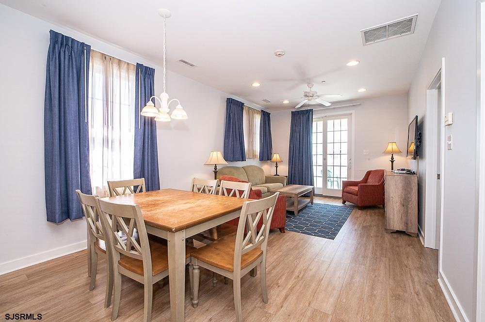 1001 Little Atlantic Avenue, Unit 373 Ocean City, NJ 08226 - Photo 7 of 27 a view of a dining room with furniture window and wooden floor