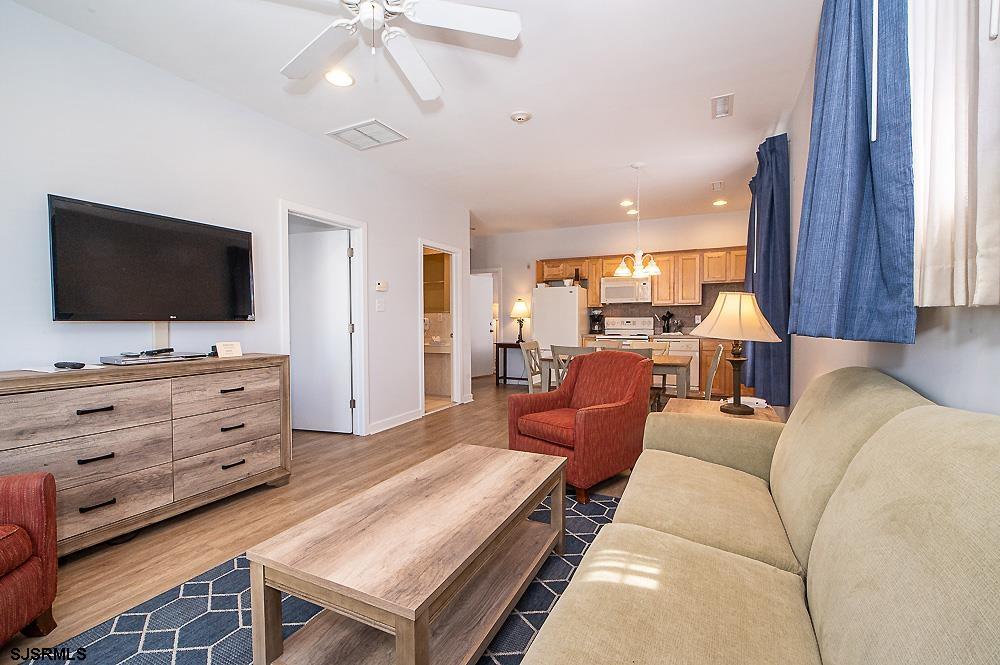 1001 Little Atlantic Avenue, Unit 373 Ocean City, NJ 08226 - Photo 9 of 27 a living room with furniture and a flat screen tv