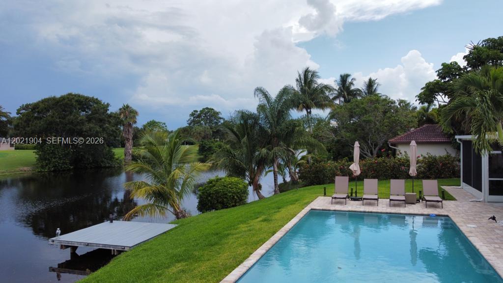 3324 Lakeview Boulevard Delray Beach, FL 33445 - Photo 32 of 36 a view of a swimming pool with a patio