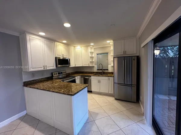 a kitchen with a refrigerator and a sink