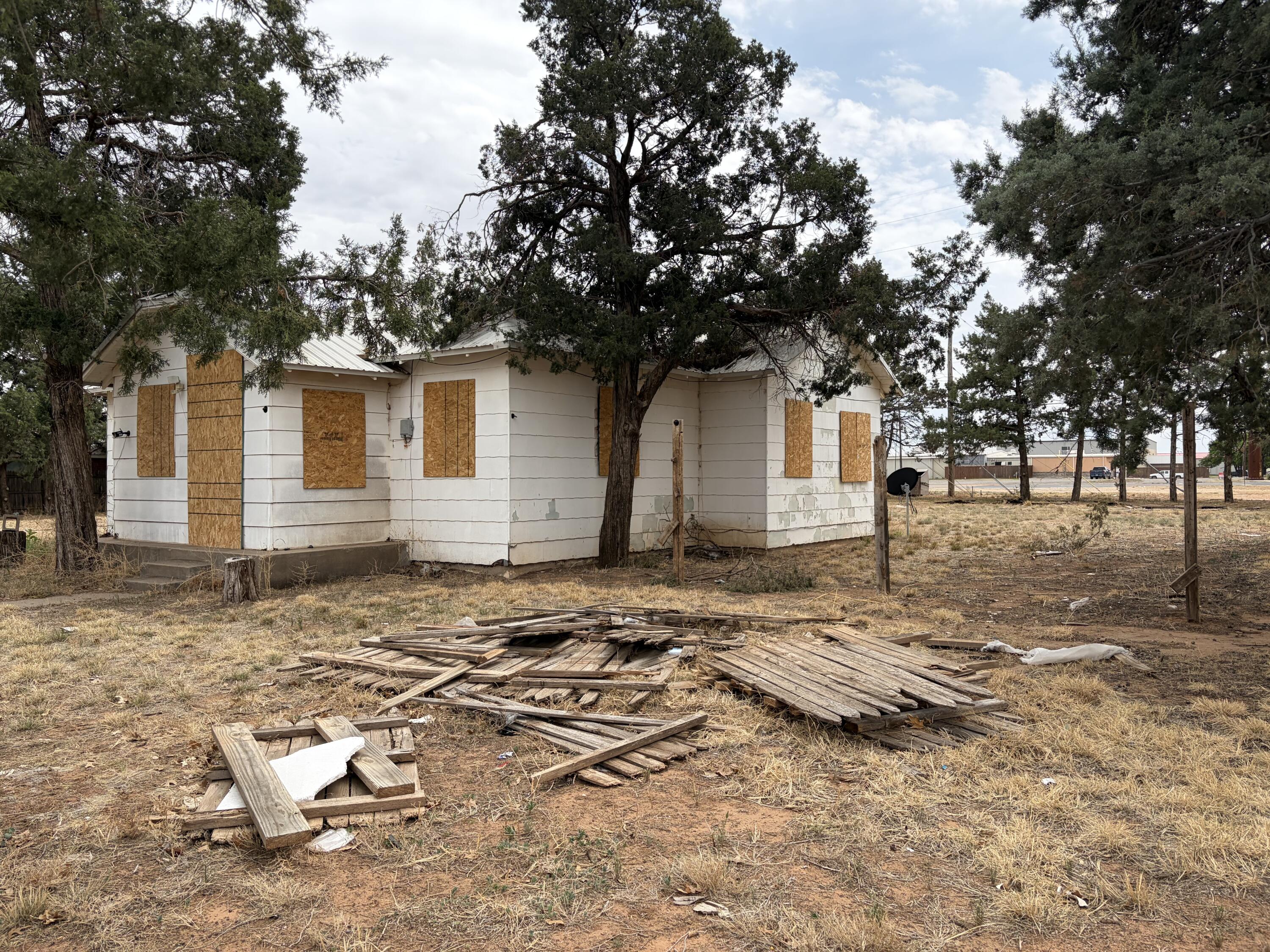 709 81st Street Lubbock, TX 79404 - Photo 2 of 3 a backyard of a house with large trees