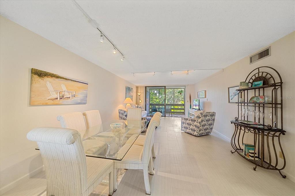 618 Bayport Way, Unit 618 Longboat Key, FL 34228 - Photo 12 of 47 a living room with furniture stairs and a window
