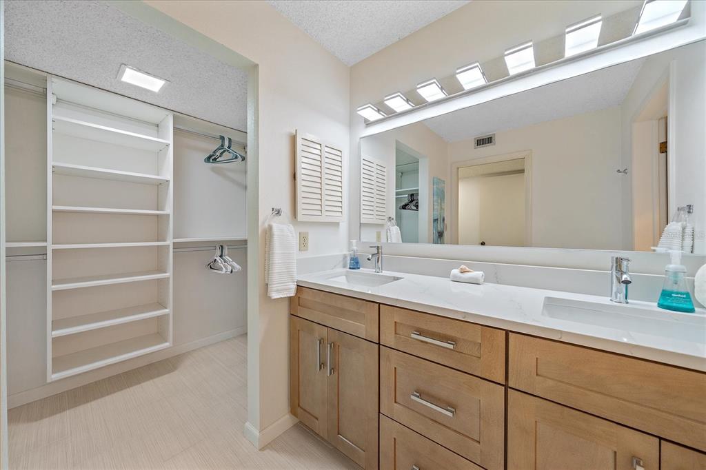 618 Bayport Way, Unit 618 Longboat Key, FL 34228 - Photo 20 of 47 a bathroom with a sink and a mirror