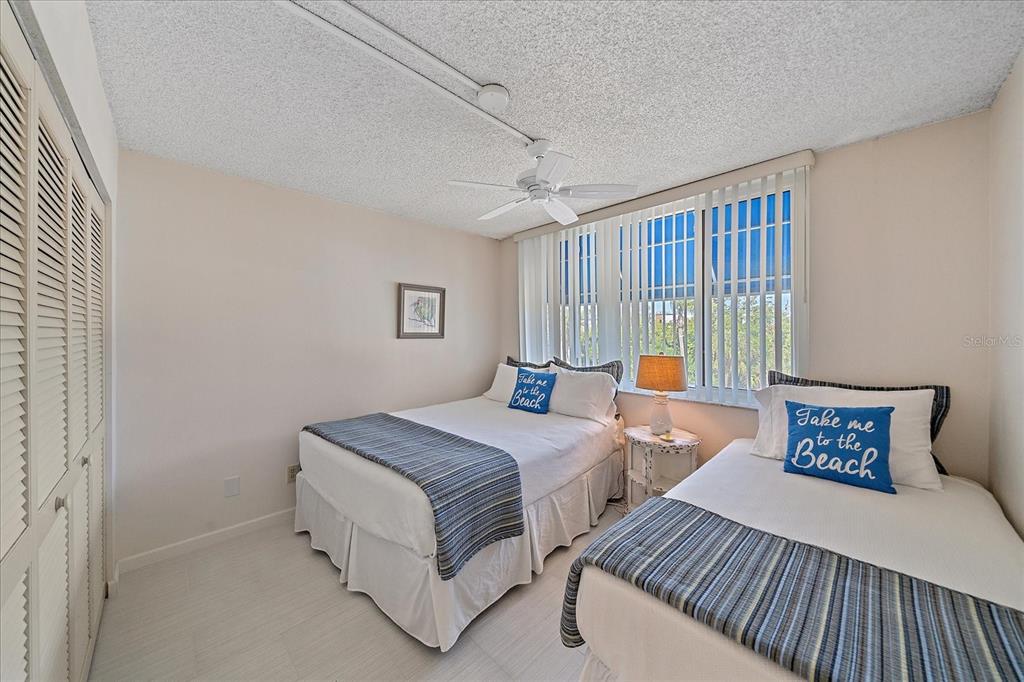 618 Bayport Way, Unit 618 Longboat Key, FL 34228 - Photo 25 of 47 a bedroom with a bed and a window