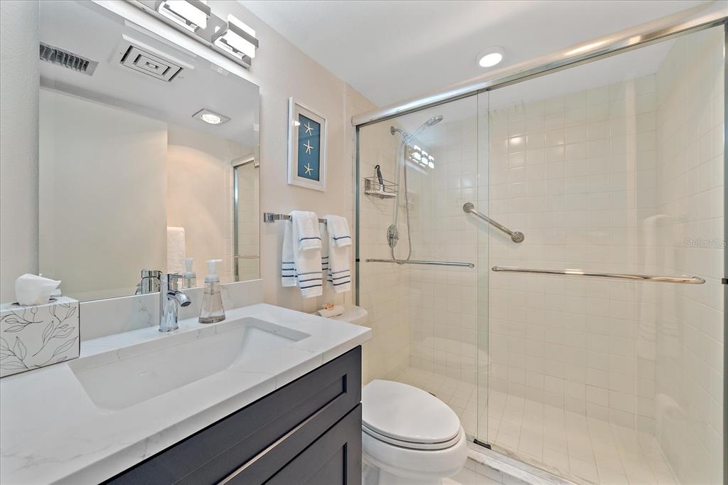618 Bayport Way, Unit 618 Longboat Key, FL 34228 - Photo 26 of 47 a bathroom with a sink a toilet and shower