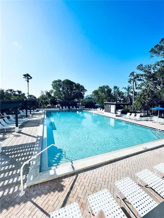 a view of swimming pool with outdoor seating