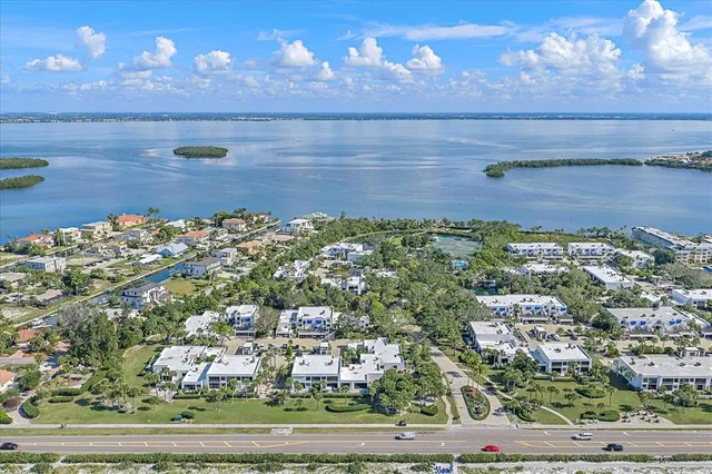 an aerial view of residential houses with outdoor space and trees