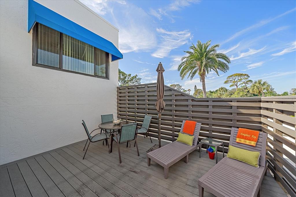 618 Bayport Way, Unit 618 Longboat Key, FL 34228 - Photo 5 of 47 a terrace with outdoor seating and wooden floor