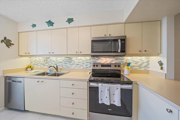 a kitchen with cabinets and window