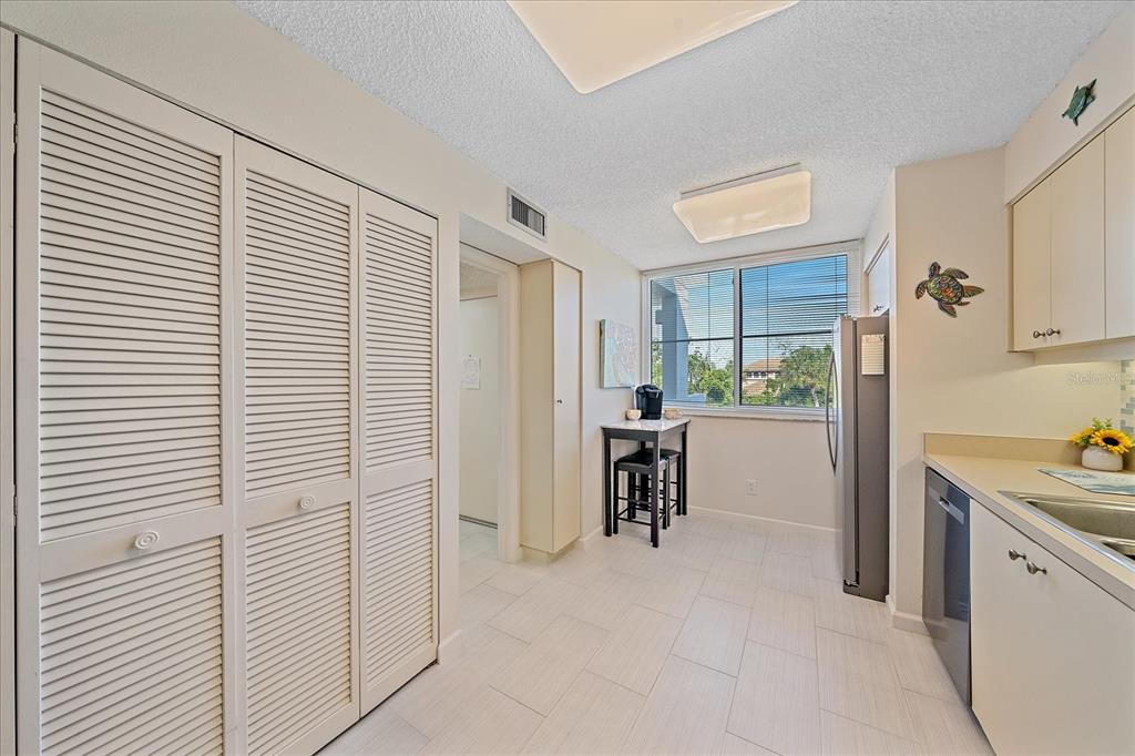 618 Bayport Way, Unit 618 Longboat Key, FL 34228 - Photo 9 of 47 a view of kitchen with furniture and refrigerator