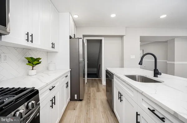 a kitchen with a sink and a refrigerator