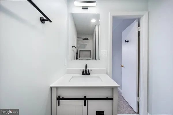 a white toilet sitting next to a bathroom sink