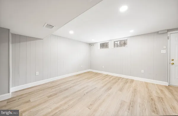 a view of an empty room with wooden floor