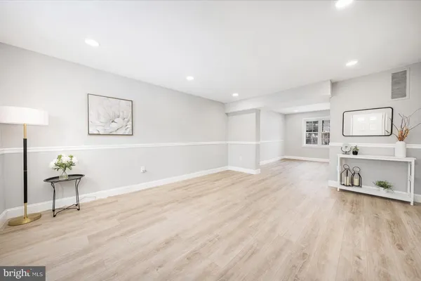 a view of a living room kitchen and a wooden floor