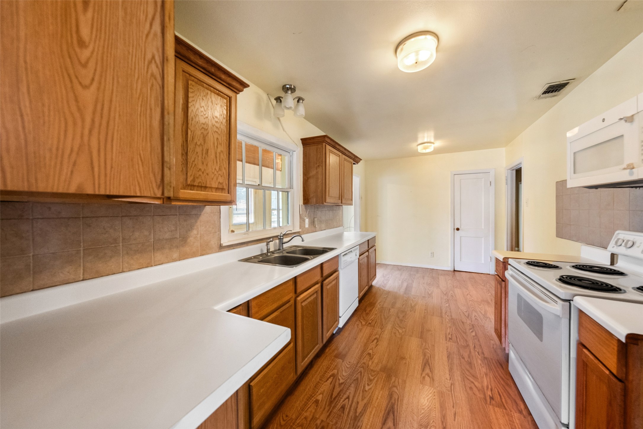 810 Main Street Hempstead, TX 77445 - Photo 13 of 32 Kitchen view highlighting ample cabinet and countertop space, natural light, and an efficient layout for everyday use.