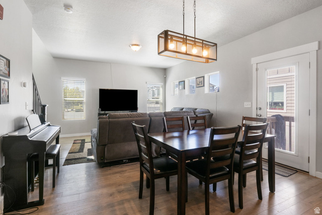 5155 East Rio Grande Way Eagle Mountain, UT 84005 - Photo 9 of 40 Dining room featuring hardwood / wood-style flooring and a textured ceiling
