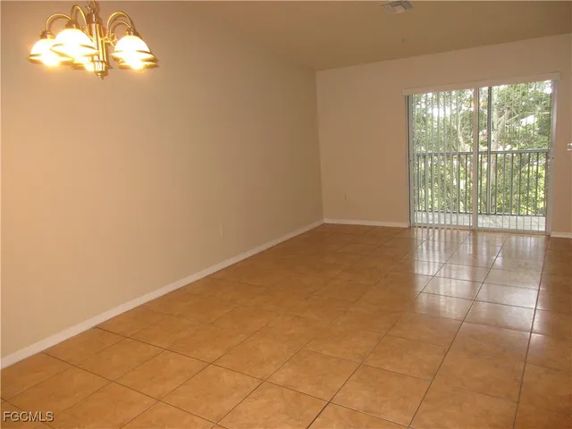 a view of empty room with floor to ceiling window