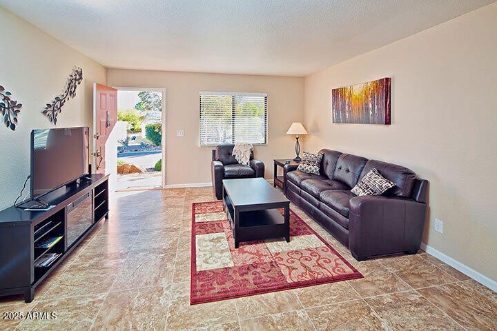 540 South West Road, Unit 29 Wickenburg, AZ 85390 - Photo 5 of 9 a living room with furniture and a flat screen tv