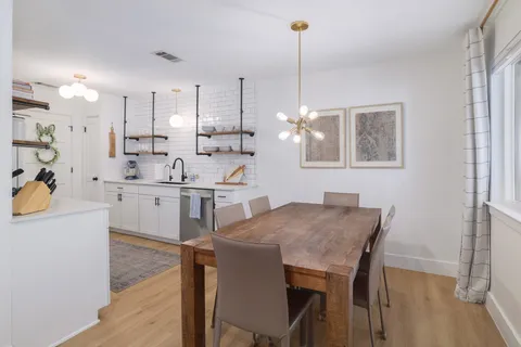 a view of kitchen with cabinets table and chairs