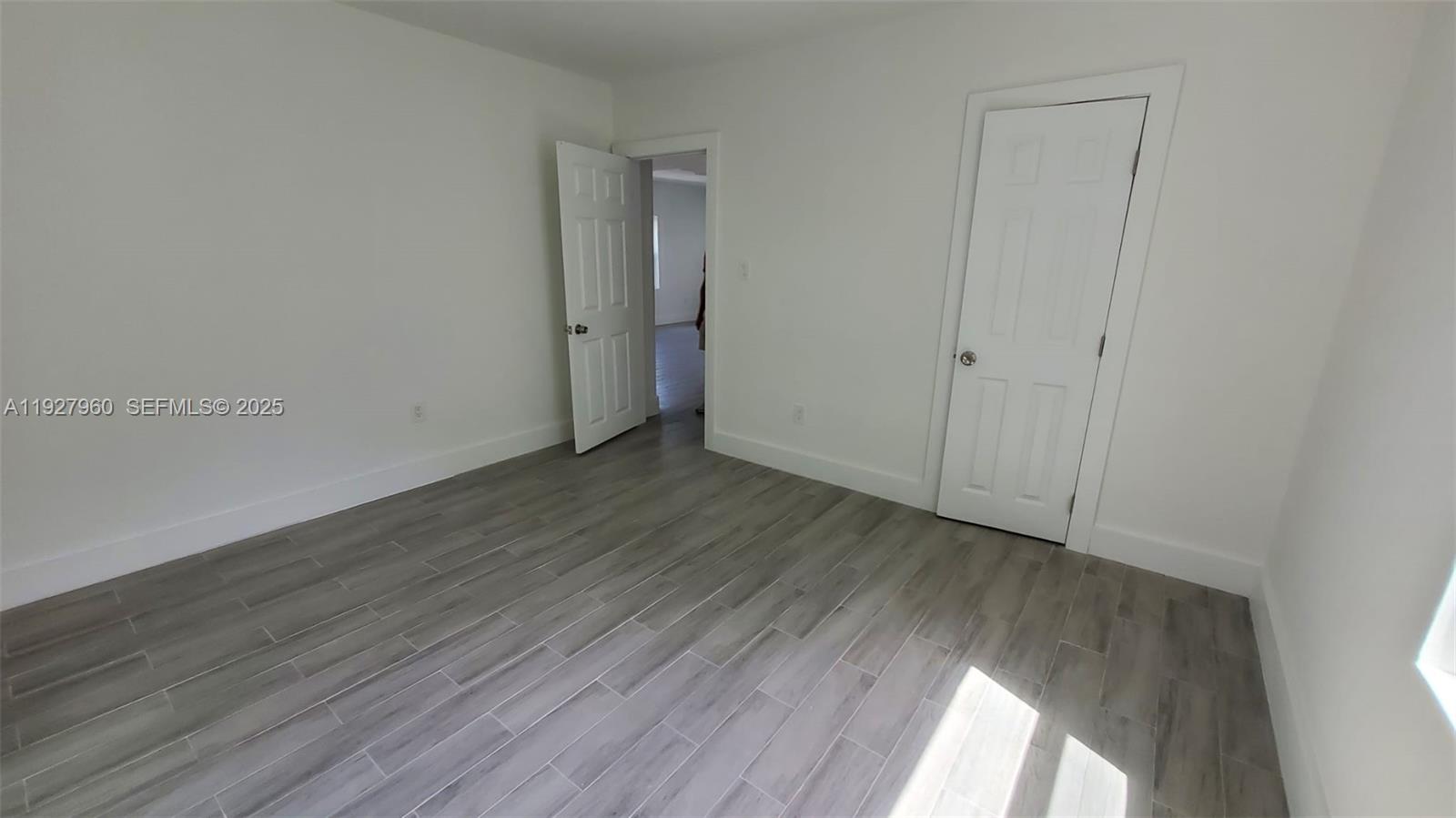 560 Northwest 53rd Street Miami, FL 33127 - Photo 11 of 12 a view of an empty room with wooden floor