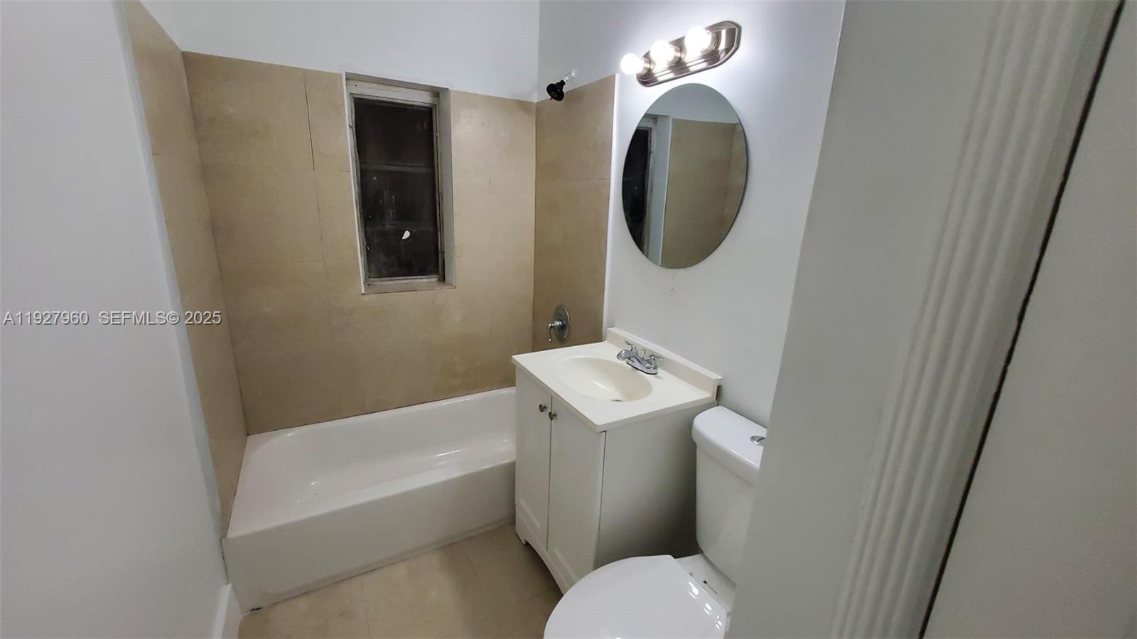 560 Northwest 53rd Street Miami, FL 33127 - Photo 4 of 12 a bathroom with a toilet sink and mirror