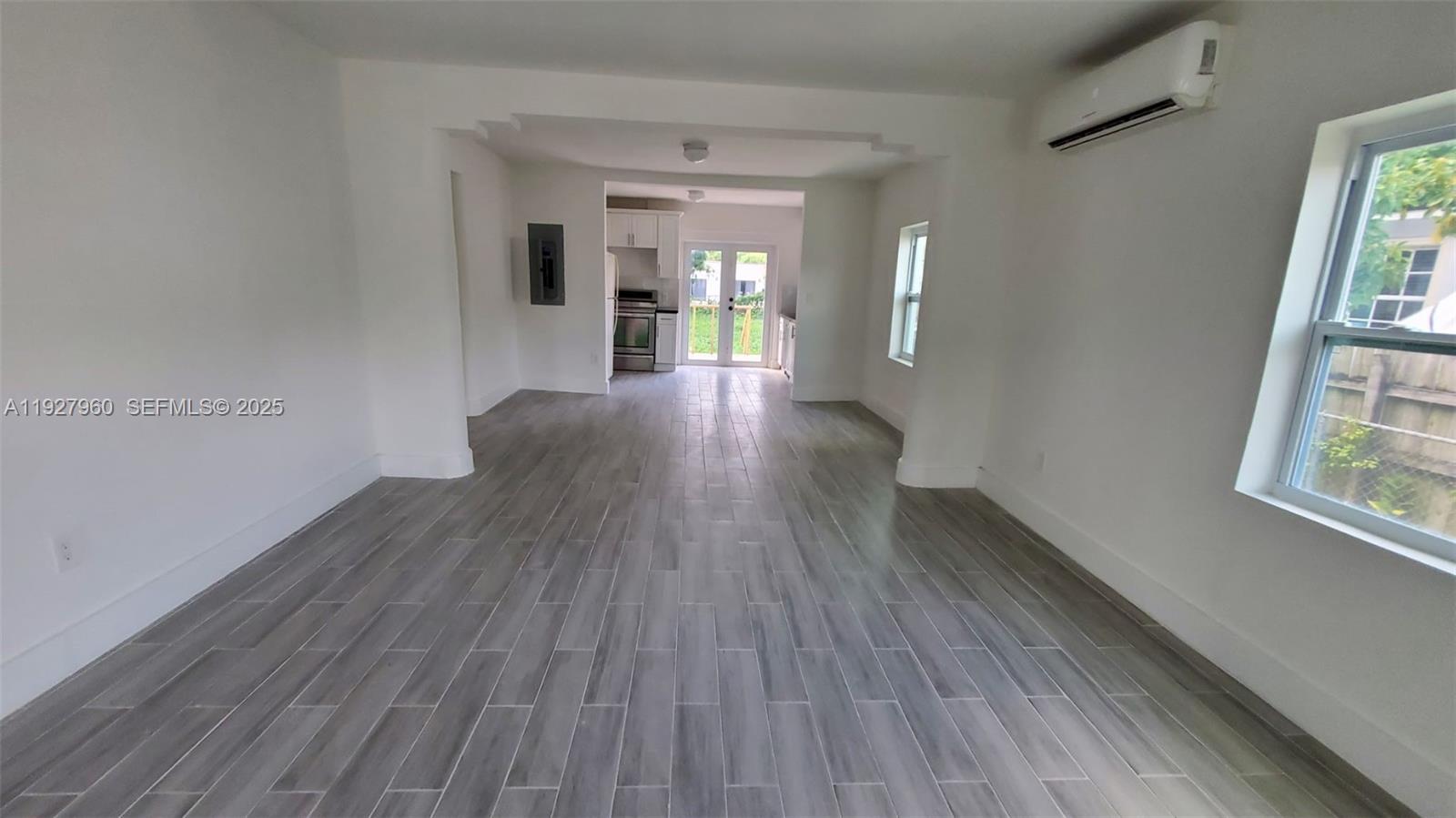 560 Northwest 53rd Street Miami, FL 33127 - Photo 10 of 12 wooden floor in an empty room with a window