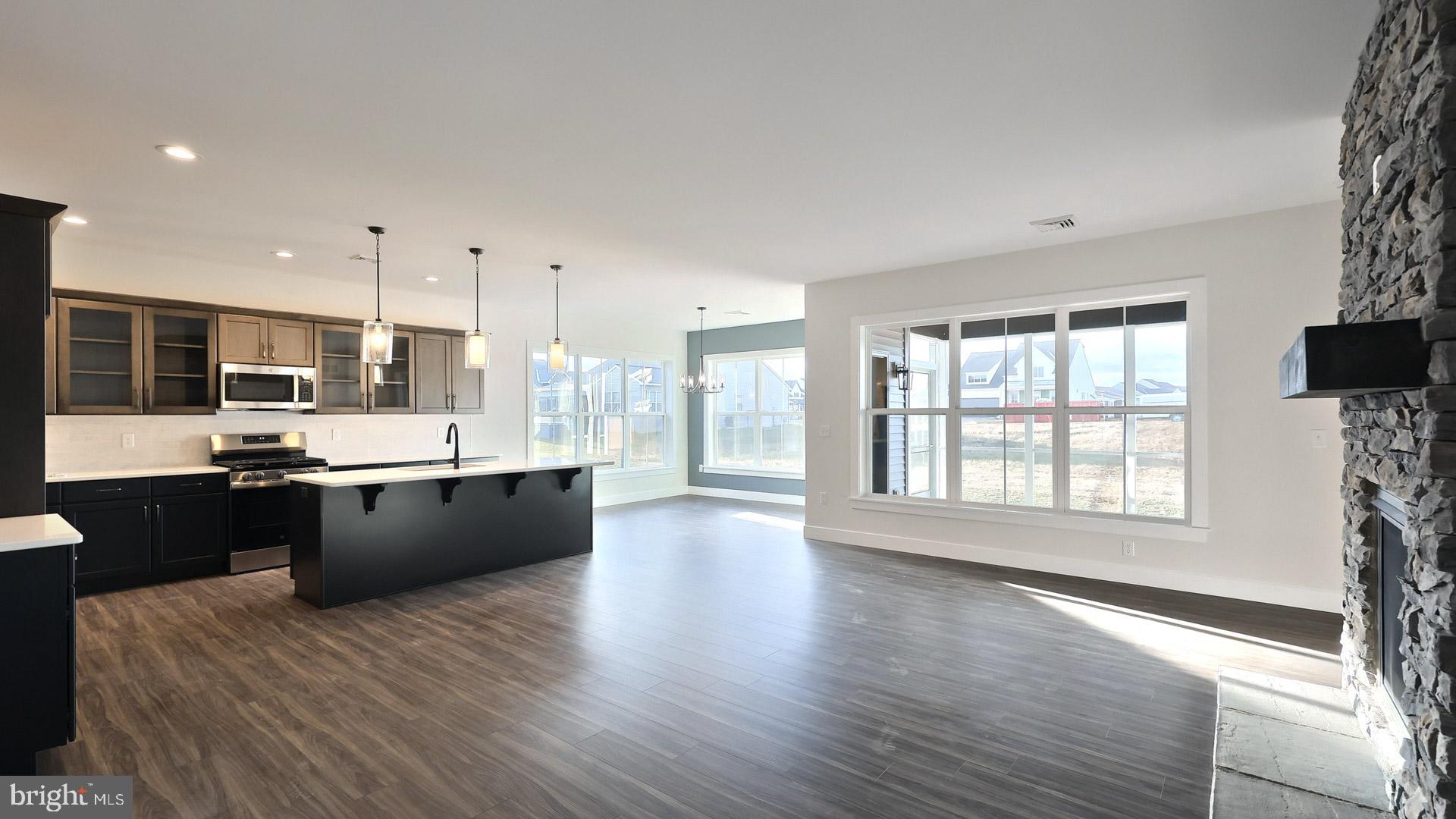 475 Pinnacle Rdg Drive Annville, PA 17003 - Photo 22 of 31 a large kitchen with stainless steel appliances kitchen island granite countertop a stove a sink a refrigerator and blue cabinets with wooden floor
