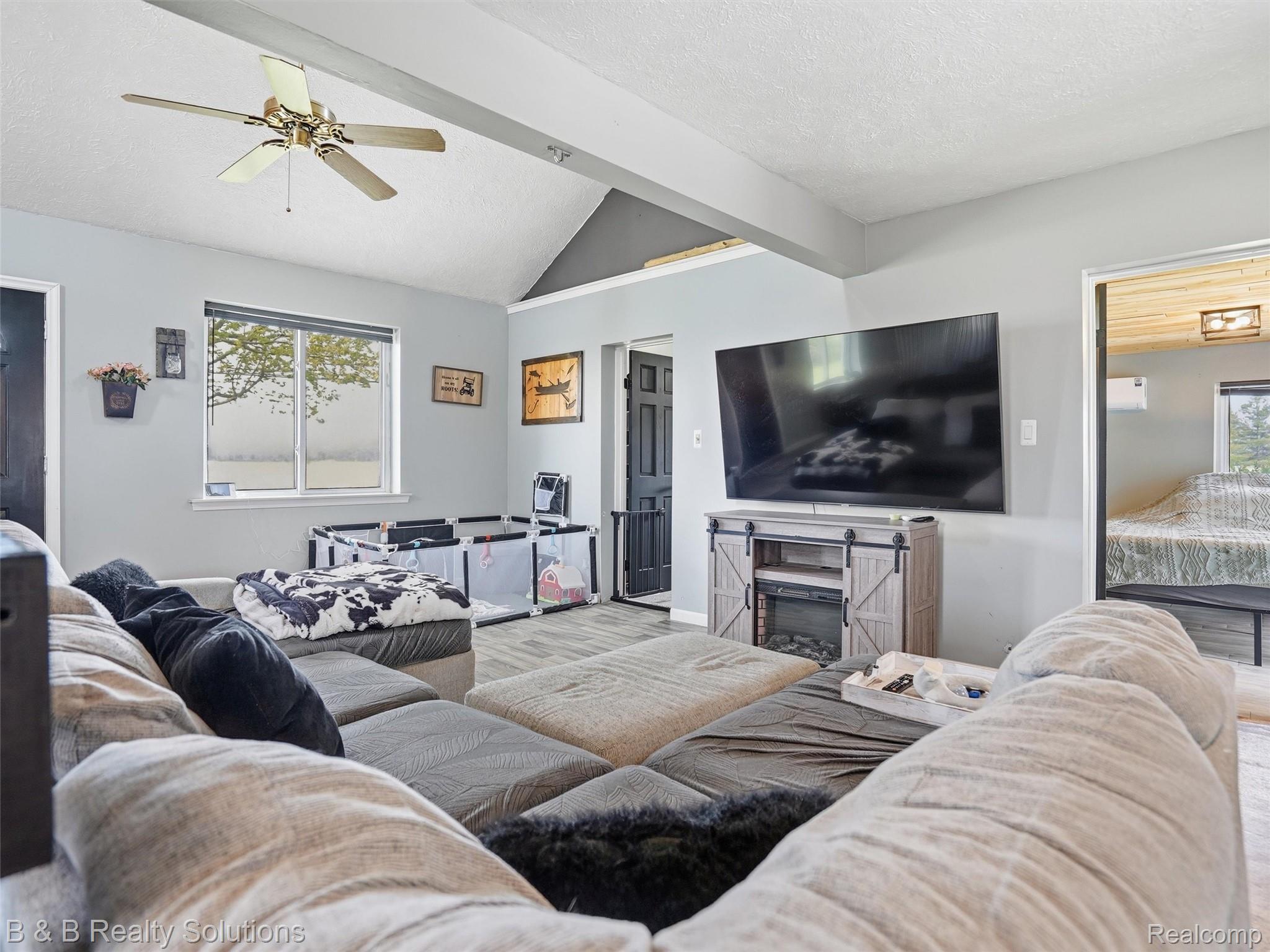 21900 Bordman Road Armada, MI 48005 - Photo 29 of 55 Living room featuring ceiling fan and beam ceiling
