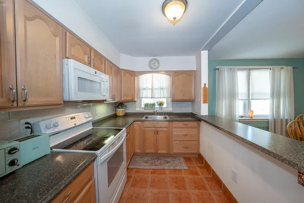 a kitchen with a sink stove and cabinets