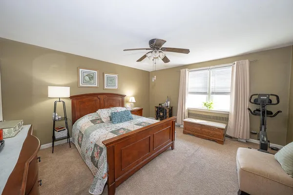 a bed room with a bed and a chandelier
