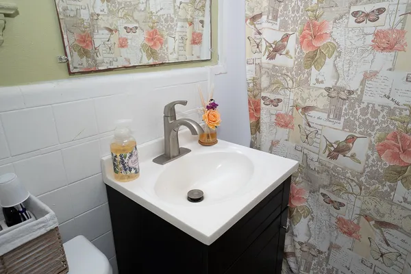 a bathroom with a sink mirror and vanity