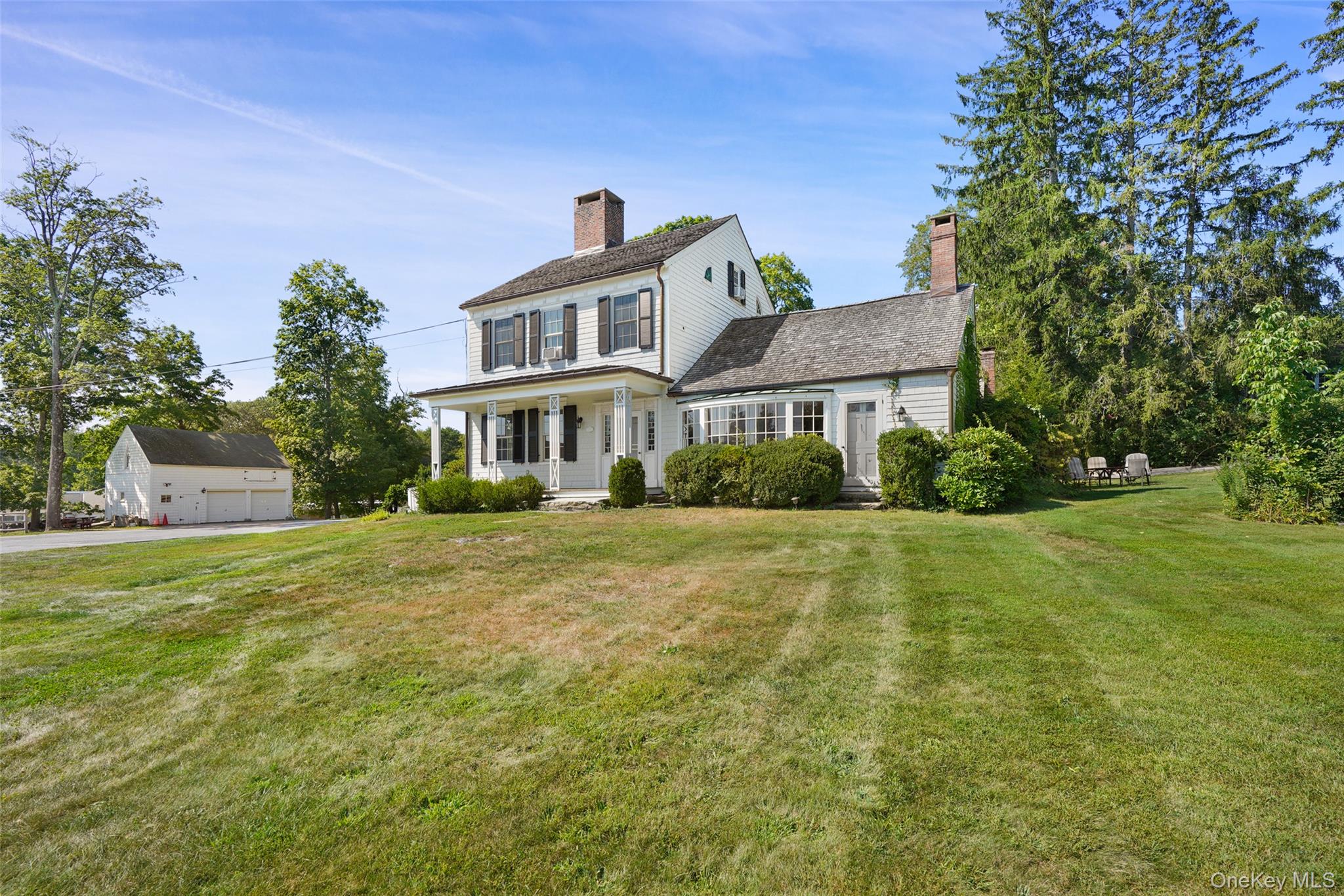 1 Pound Ridge Road Pound Ridge, NY 10576 - Photo 2 of 26 Colonial home with a porch, a chimney, a front lawn, and a detached garage 1 bay for renter