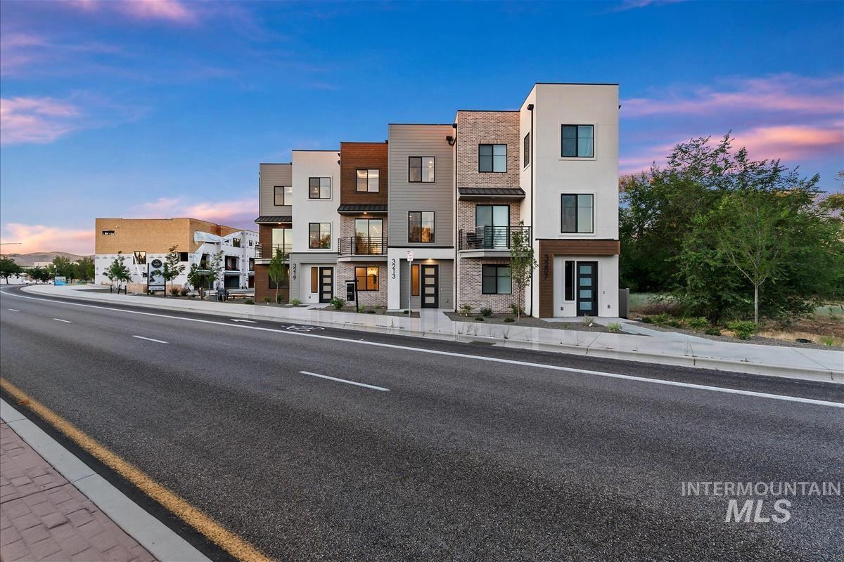 3213 West Moore Street Boise, ID 83702 - Photo 29 of 32 Modern townhouse row featuring varied façade materials including brick, stucco, and wood-finish accents