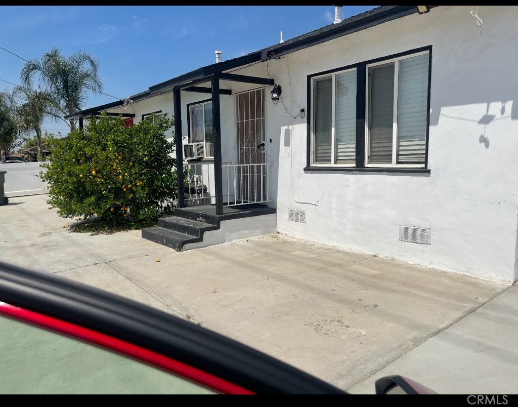 15356 Merrill Avenue, Unit 1 Fontana, CA 92335 - Photo 1 of 8 a front view of a house with garden