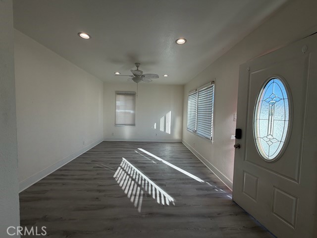 15356 Merrill Avenue, Unit 1 Fontana, CA 92335 - Photo 2 of 8 a view of an empty room with wooden floor and a window