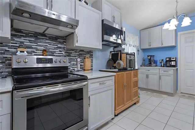 a kitchen with a sink dishwasher a refrigerator and cabinets