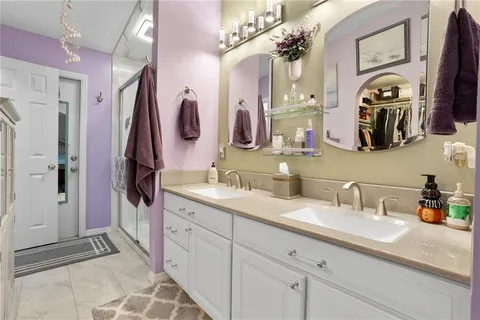 a bathroom with a double vanity sink and a mirror