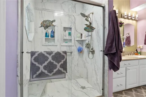 a bathroom with a mirror and a shower