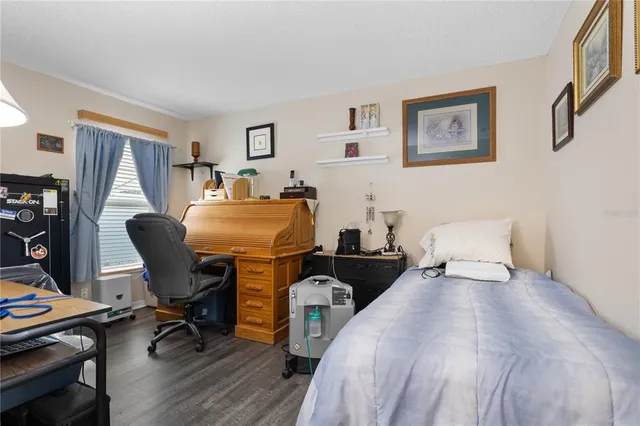 a bedroom with two beds and a desk
