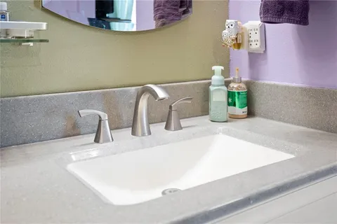 a bathroom with a sink vanity and mirror