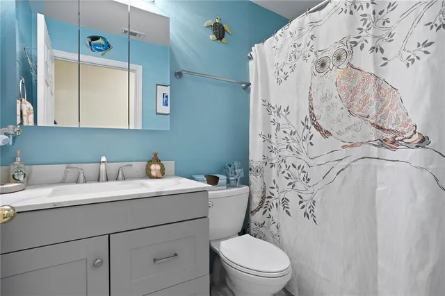 a bathroom with a sink a toilet and bathtub