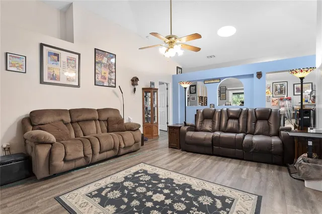 a living room with furniture a couch and wooden floor