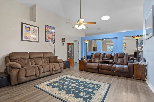 a living room with furniture a rug and a chandelier