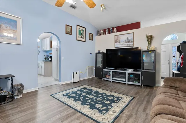 a living room with furniture and a flat screen tv