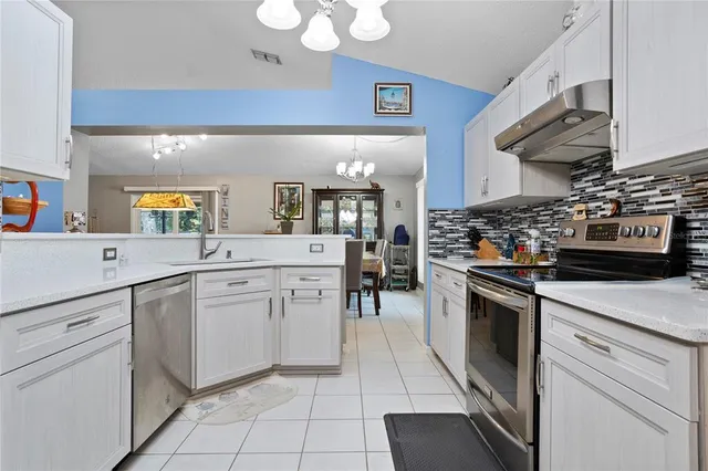 a kitchen with stainless steel appliances granite countertop a stove and a sink