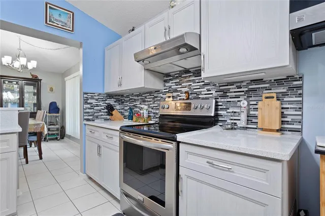 a kitchen with cabinets and white appliances