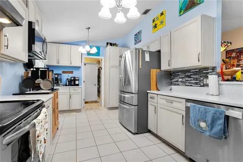 a kitchen with a white cabinets and white appliances