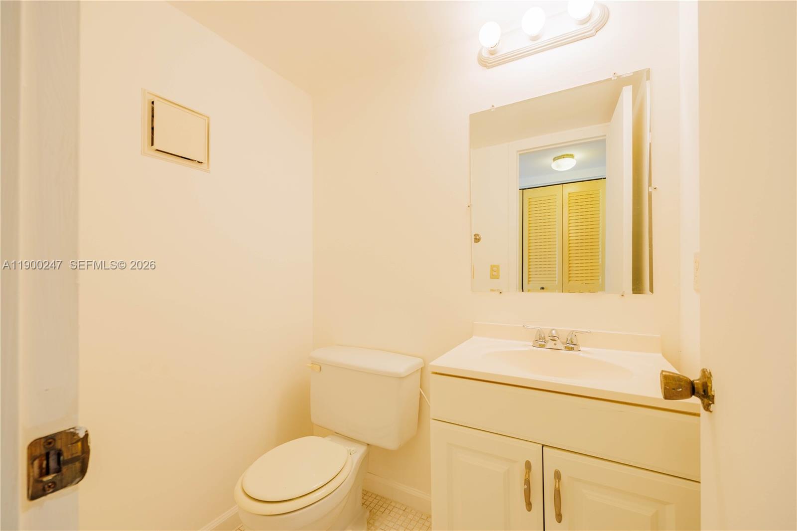 303 Preston H, Unit 303 Boca Raton, FL 33434 - Photo 14 of 50 a bathroom with a sink a toilet and mirror