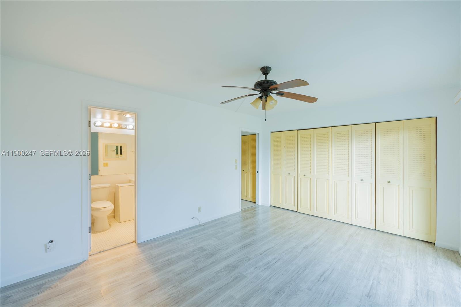 303 Preston H, Unit 303 Boca Raton, FL 33434 - Photo 18 of 50 a view of empty room with wooden floor and fan