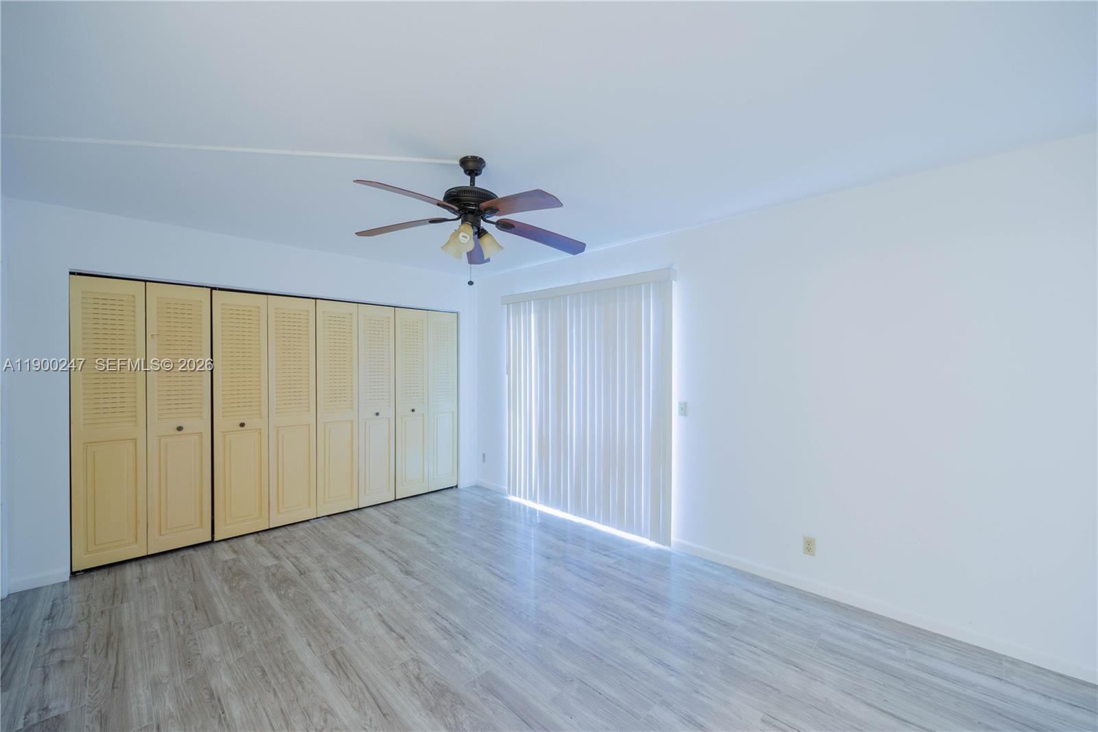 303 Preston H, Unit 303 Boca Raton, FL 33434 - Photo 19 of 50 a view of an empty room and wooden floor